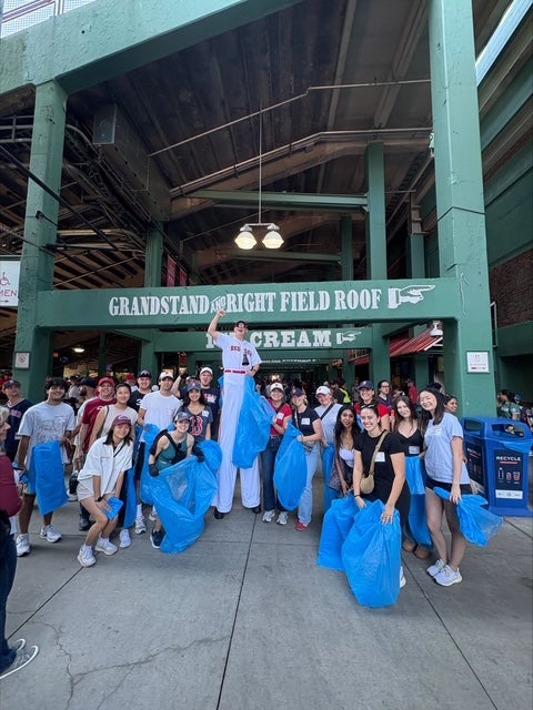 Volunteers pose outside Fenway after filling bags with recyclables