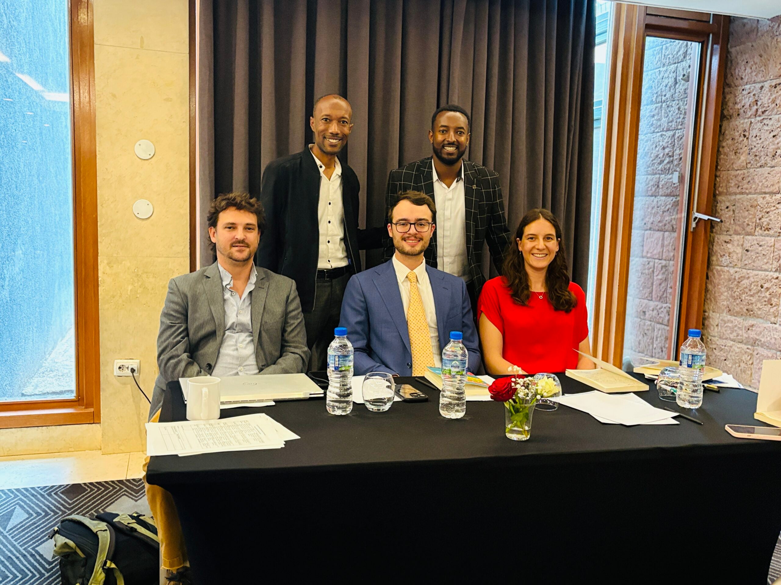 Members of the Health Systems Innovation Lab sit at a table.