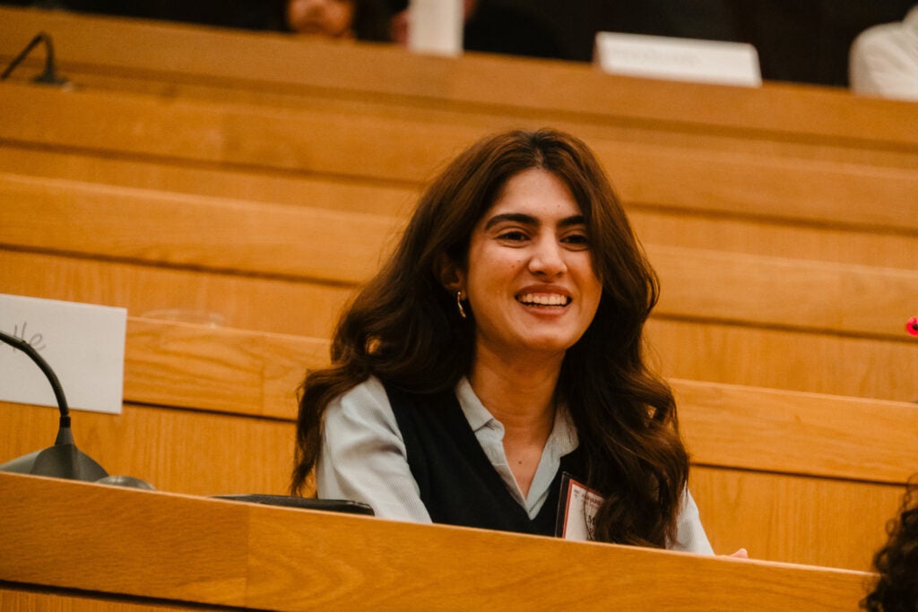 An alumna smiles while listening to the case study. 