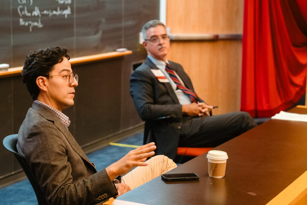 Austin Crumpton and José Acosta lead a discussion on the role of AI in public health. 