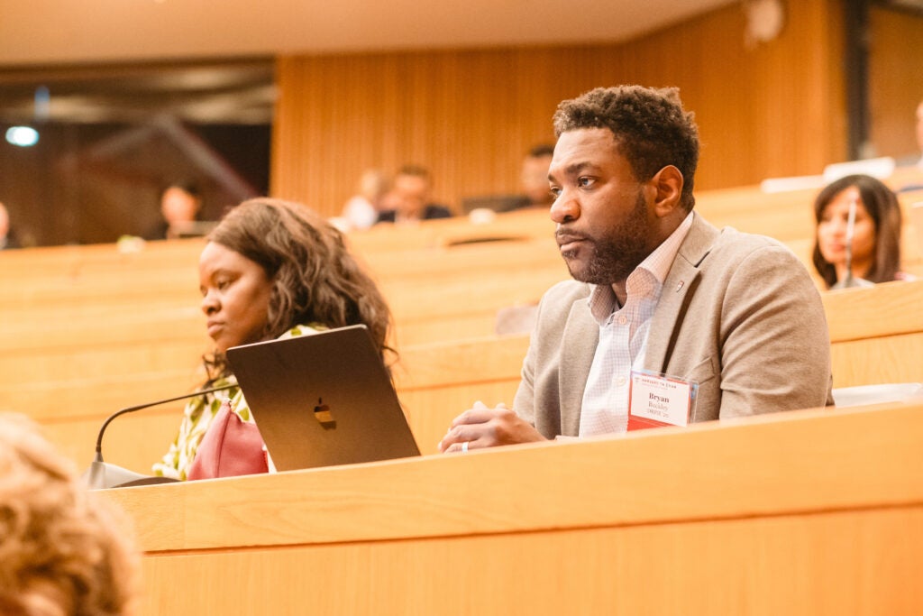 Alumni listen attentively to the case study presentation. 