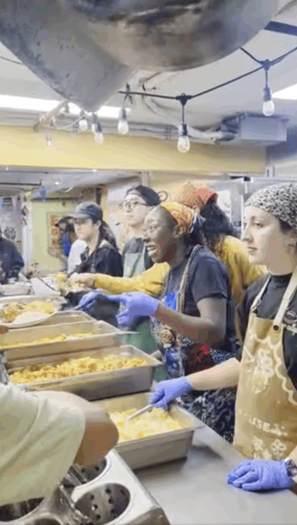 Volunteers serve lunch at a shelter