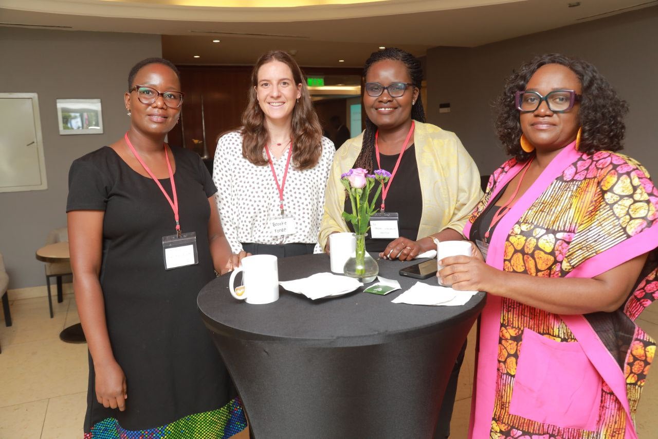 Brooke Forde and participants stand at table.