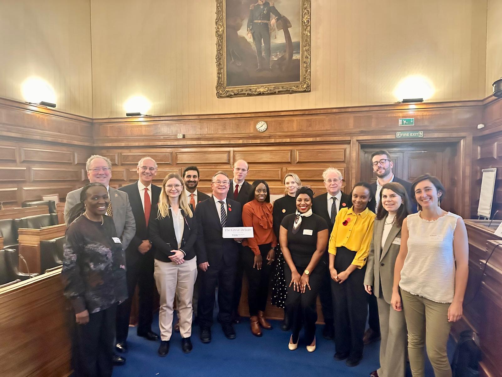 Participants in the debate pose together.