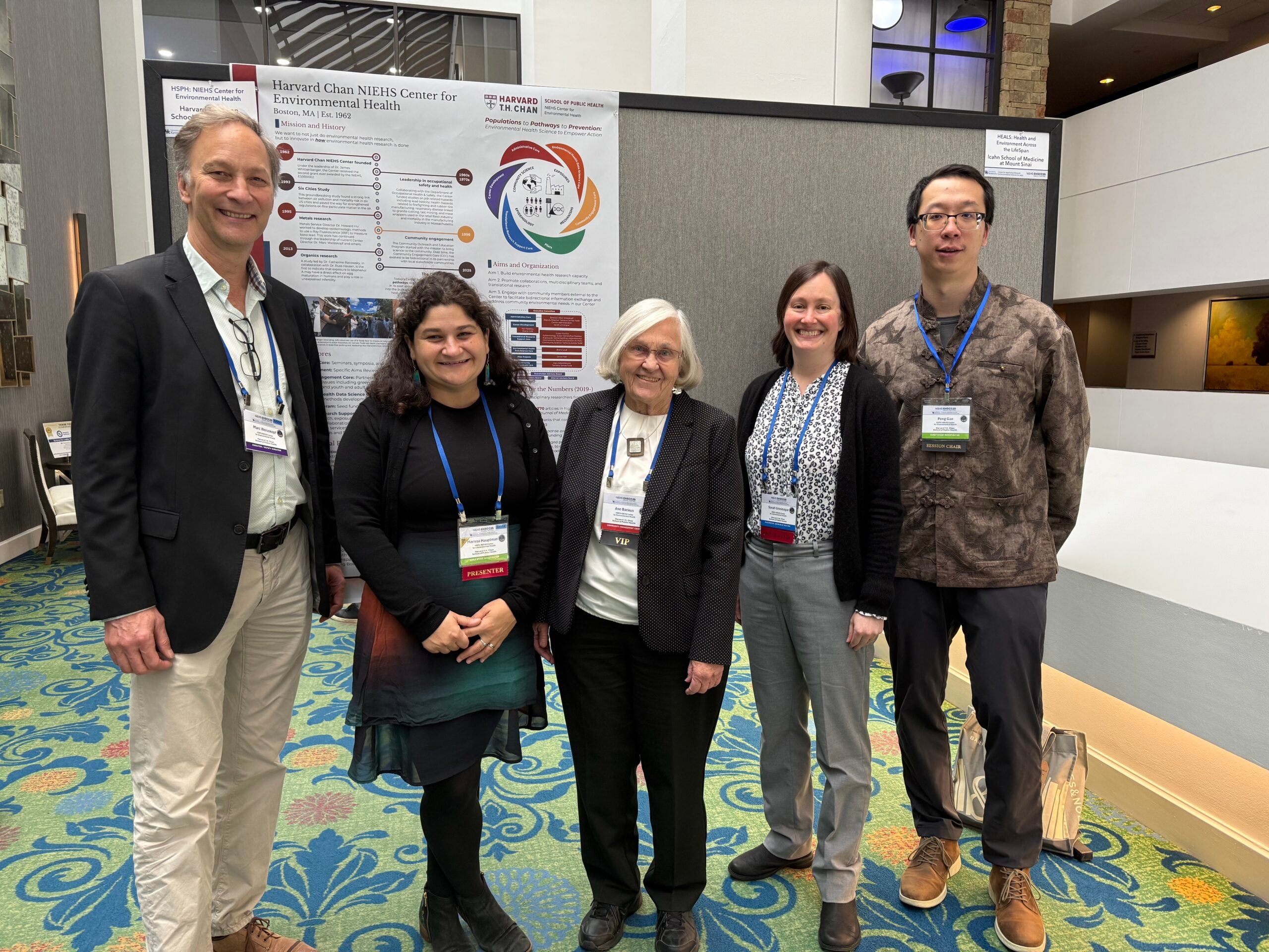 Harvard Chan NIEHS Center delegates to the 2025 EHSCC Annual Meeting stand in front of the Harvard poster.