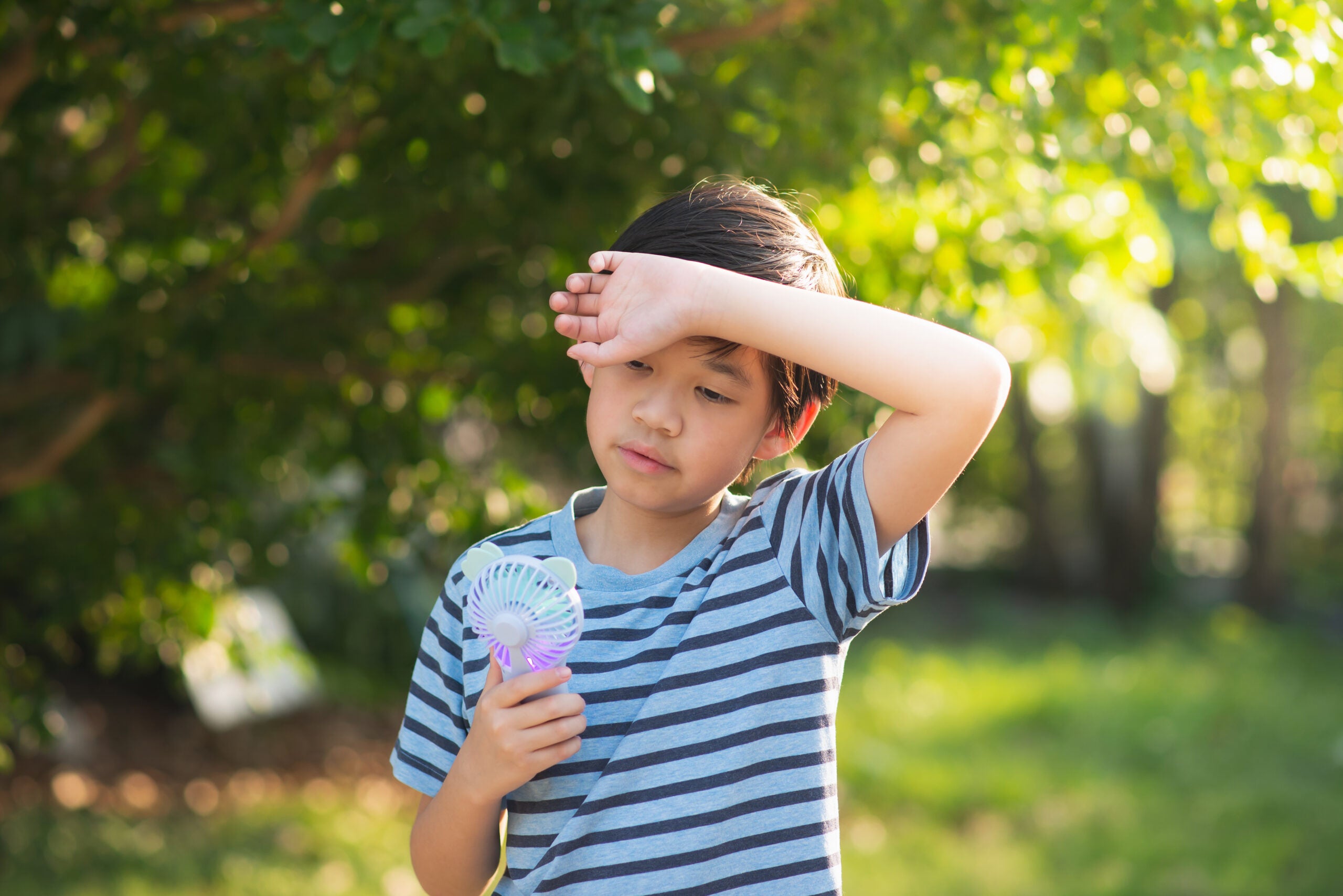 Child using a handy fan