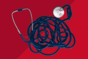A tangled stethoscope on a red background