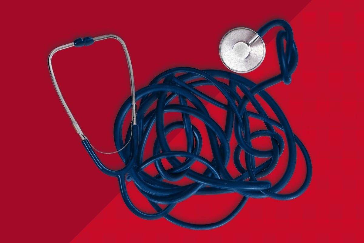 A tangled stethoscope on a red background