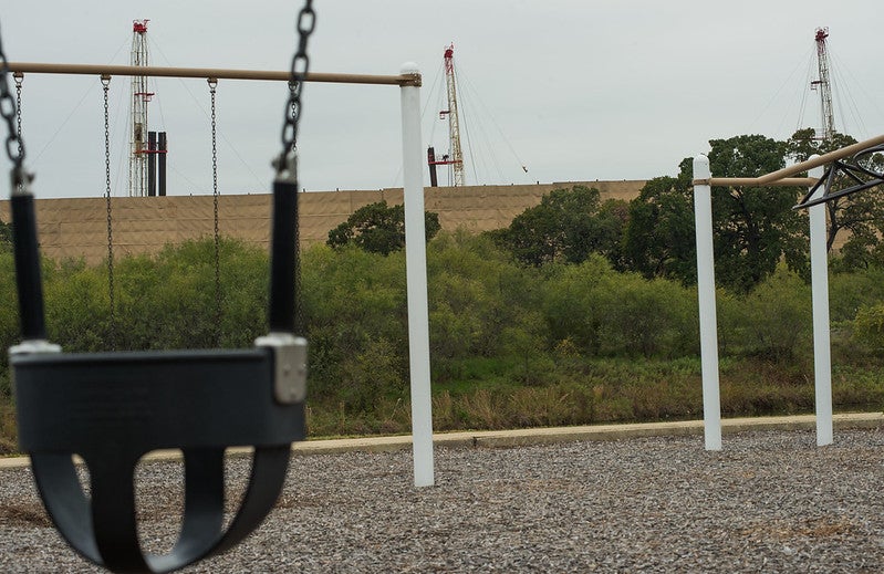 OIl & gas development near playground and swings