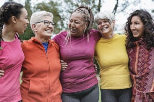 Multi generational women having fun together at park - Multiracial people meet and hugging each other outdoor