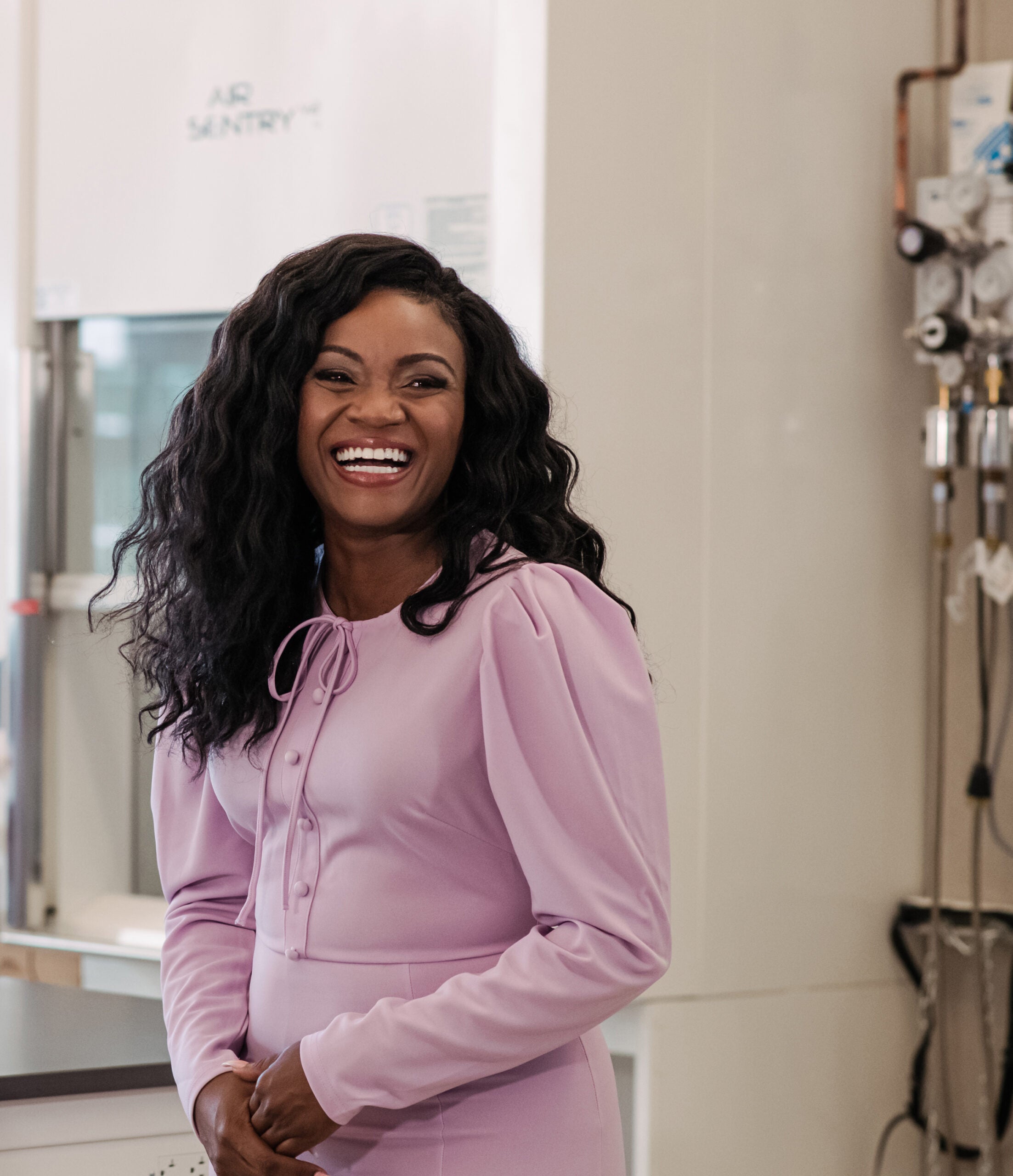 Kizzmekia S. Corbett-Helaire standing in a lab during a visiti at UMBC