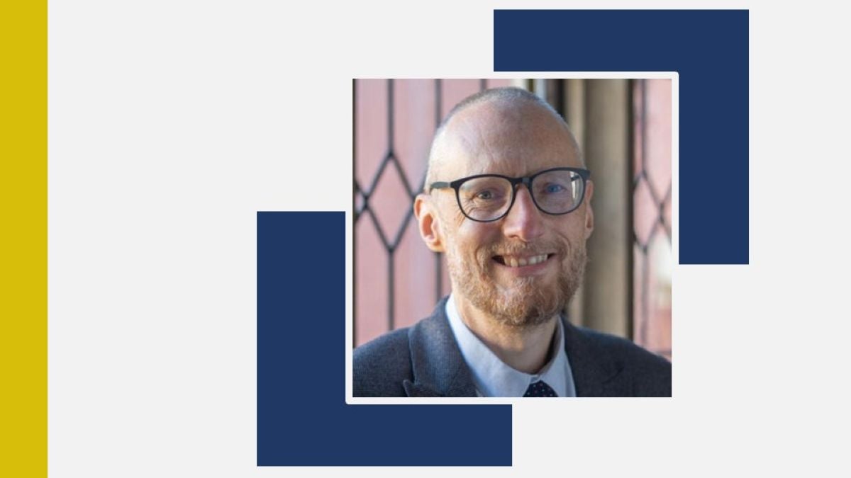 Headshot of Mark Strong Against Decorative Background