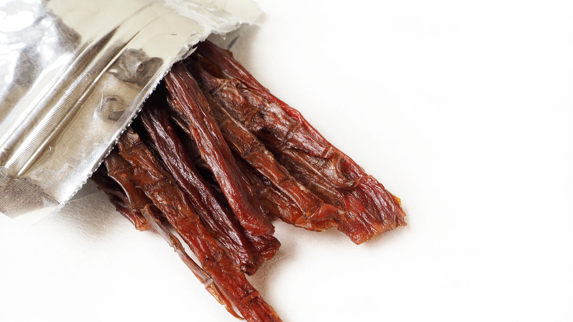 Pieces of beef jerky sticking out of an open packet