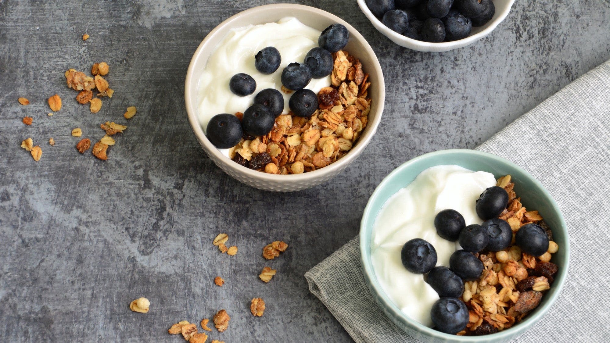 bowls of yogurt with granola and blueberries