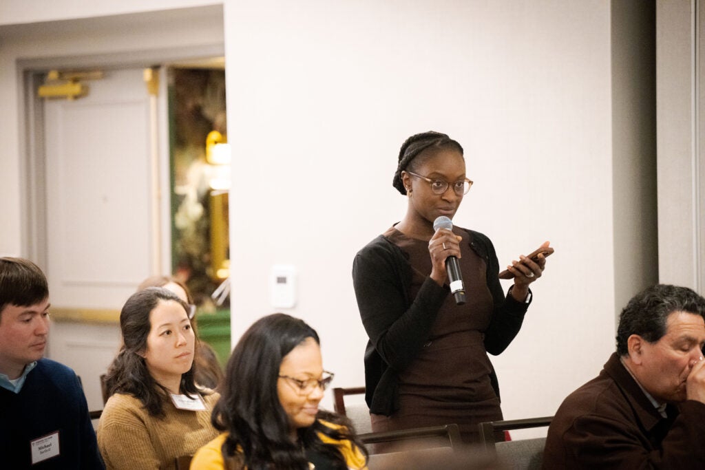 An audience member asks a question into the microphone. 