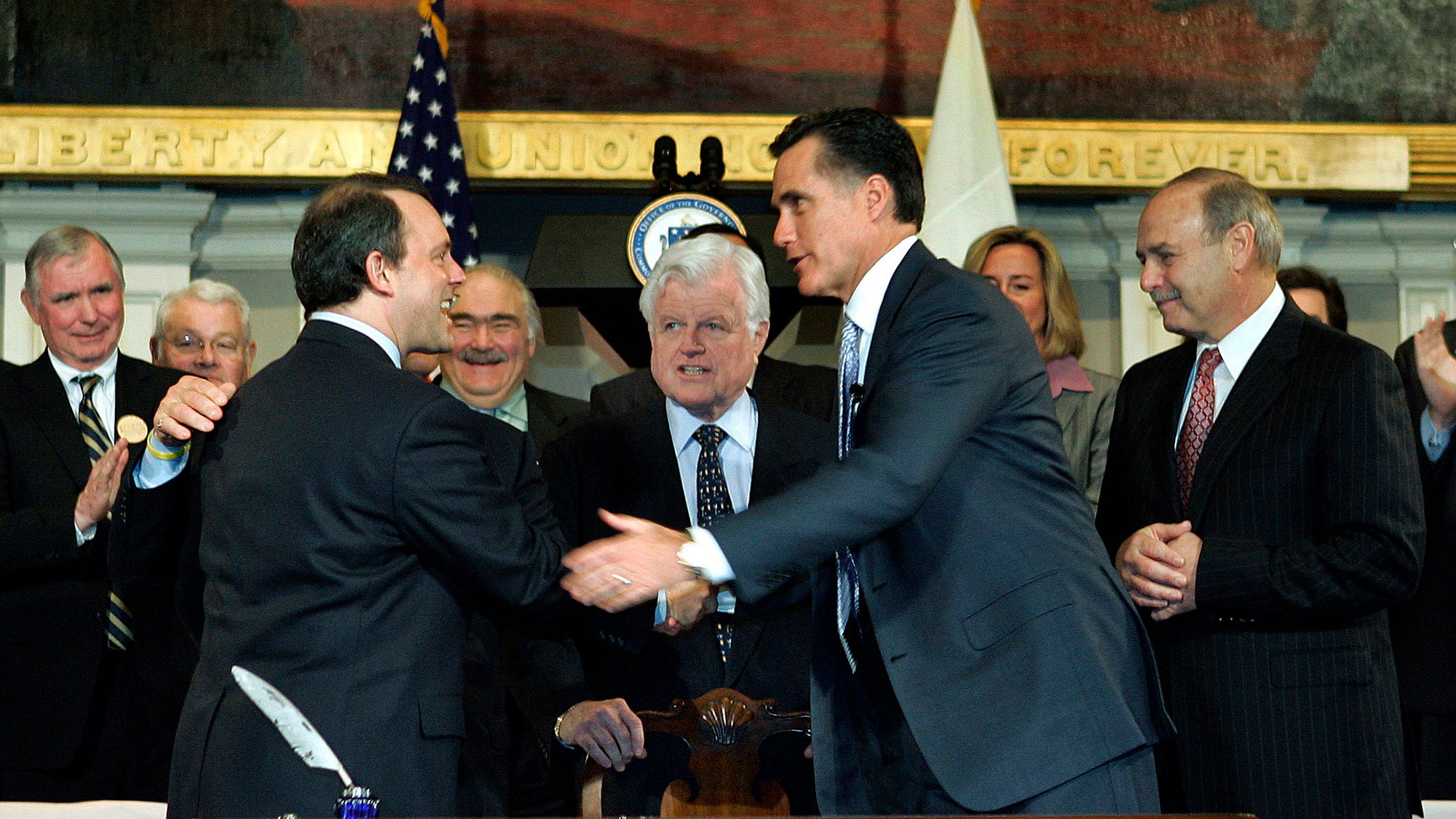 At the signing of Chapter 58, Massachusetts' landmark health care law, in 2006: Gov. Mitt Romney shakes hands with Lt. Gov Tim Murphy. Also pictured: U.S. Sen. Ted Kennedy and Speaker of the Massachusetts House of Representatives Sal DiMasi. Photo: Elise Amendola / AP