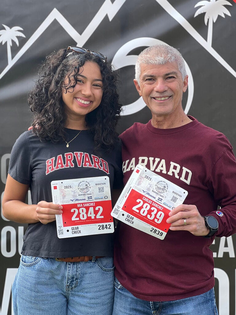 Mia Sanchez and Carlos Sanchez with qualifying numbers for the Boston Marathon