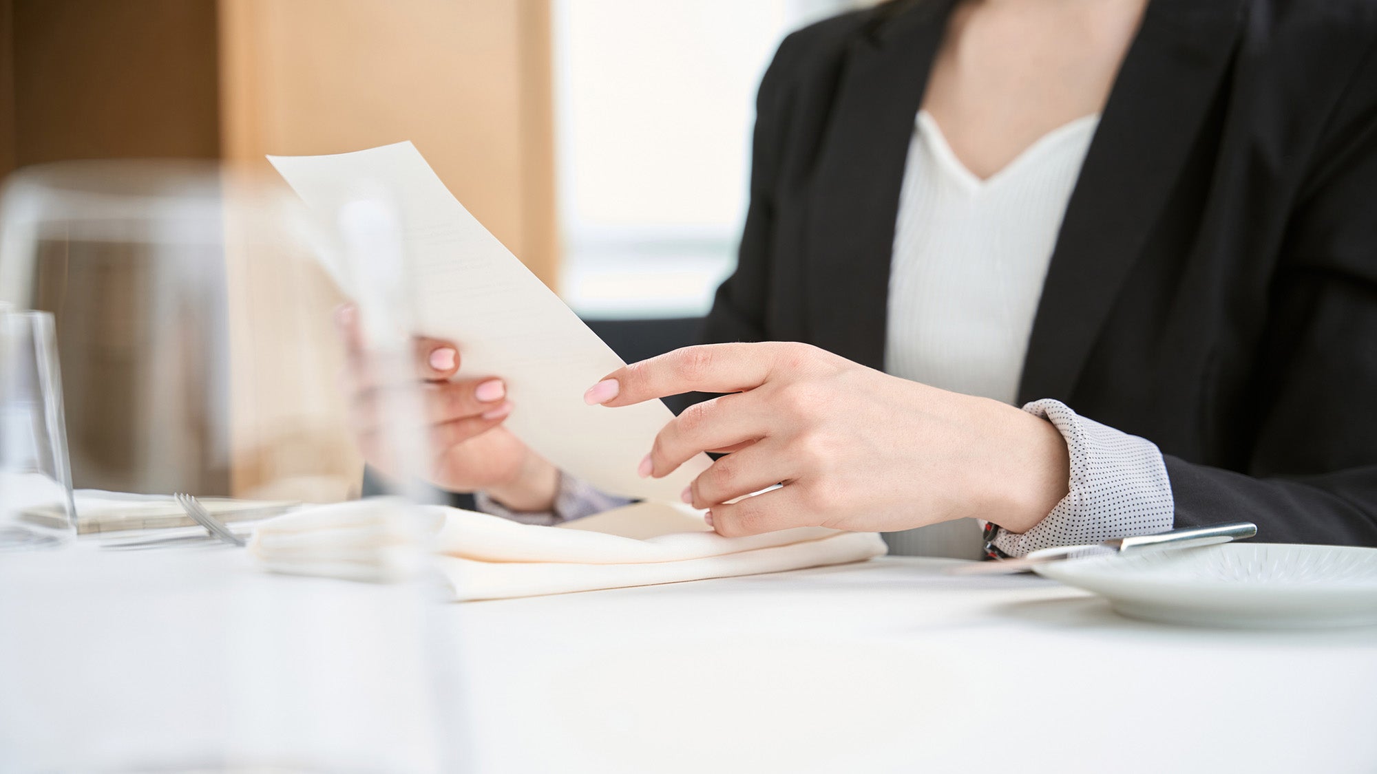 Woman in restaurant reading a menu