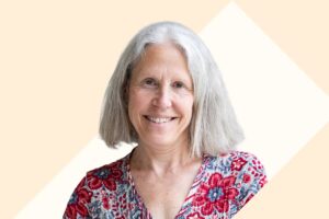 Headshot of Gabriella Stern against a cream and tan background.