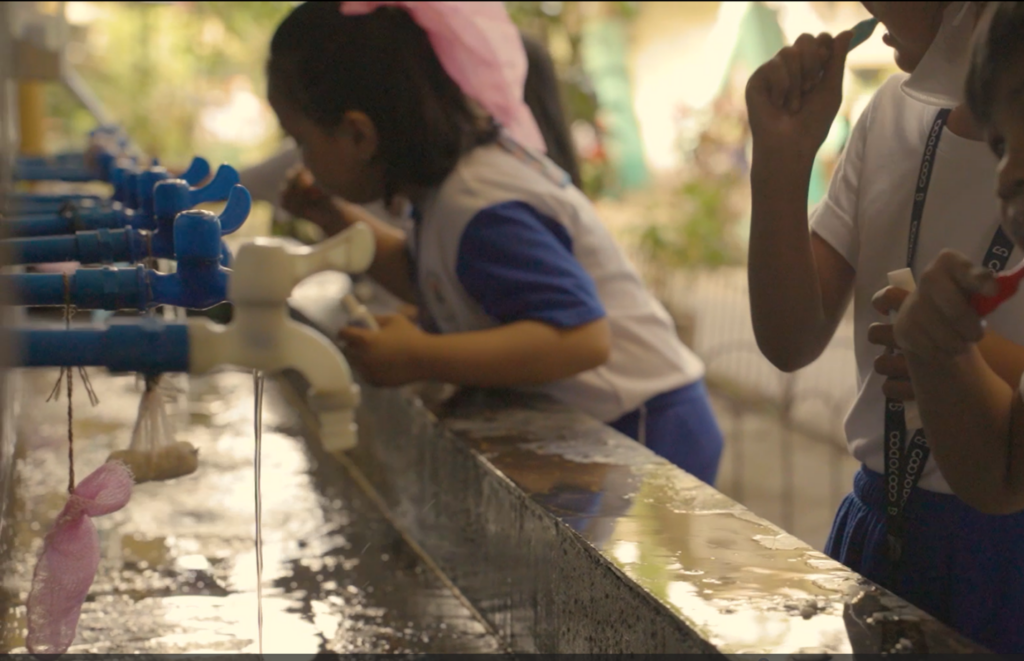 Kindergarten students putting what they learned about dental hygiene into practice.