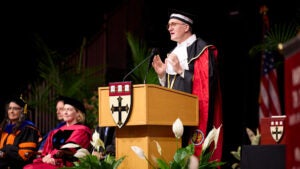 Dean Andrea Baccarelli speaking at a podium