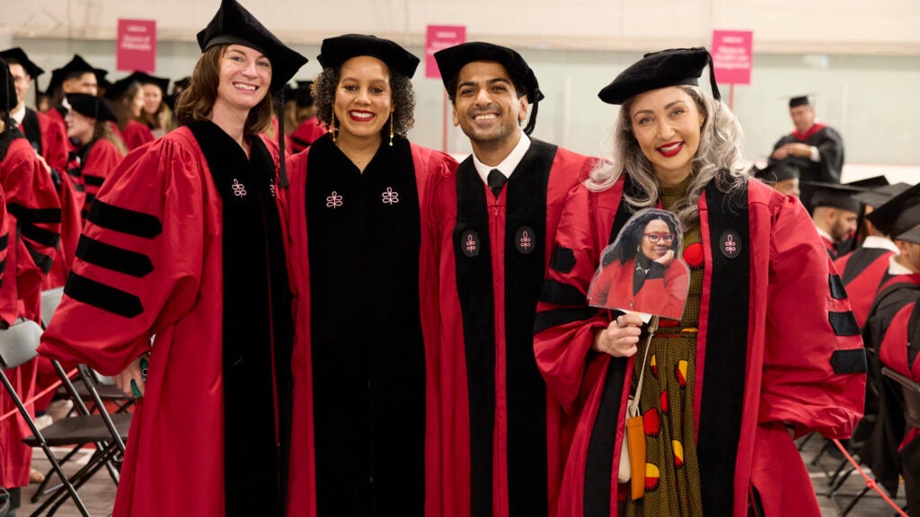Four smiling graduates