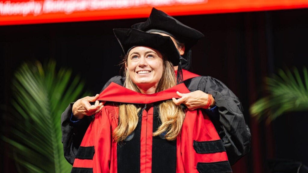 A graduate receives her hood