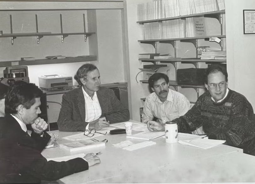HPFS researchers meet around a table