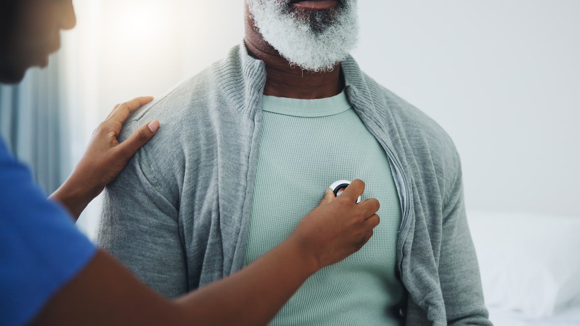 Nurse checking patient with stethoscope