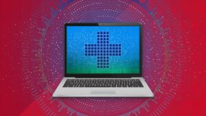 Image of a laptop displaying a medical cross on a blue, green background