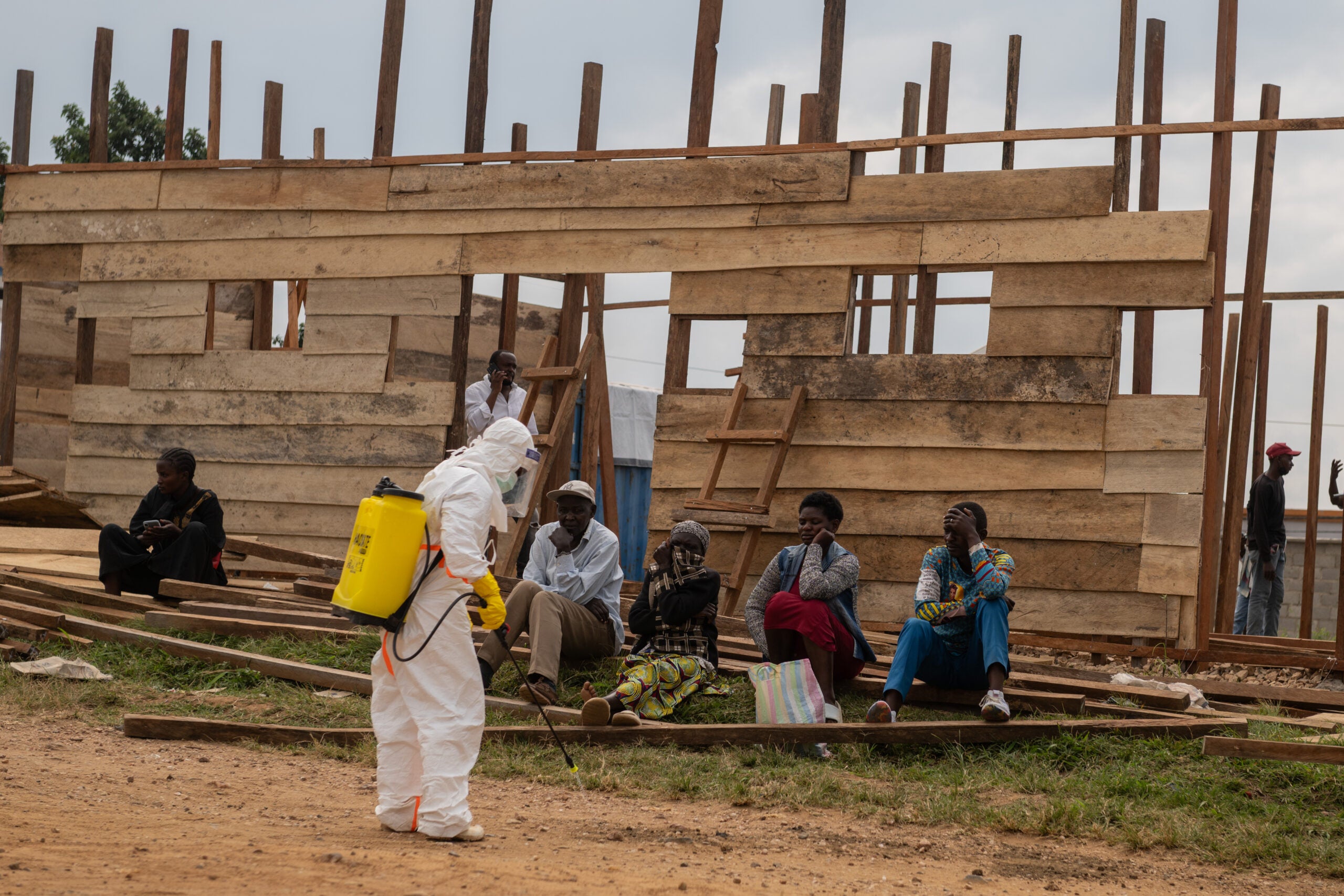 A health worker disinfects the area around a treatment center under construction at the General Hospital in Bunia, Congo, Monday, June 15, 2026.