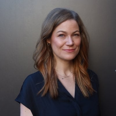 Sarah Owermohle is pictured from the shoulders up wearing a navy blouse.