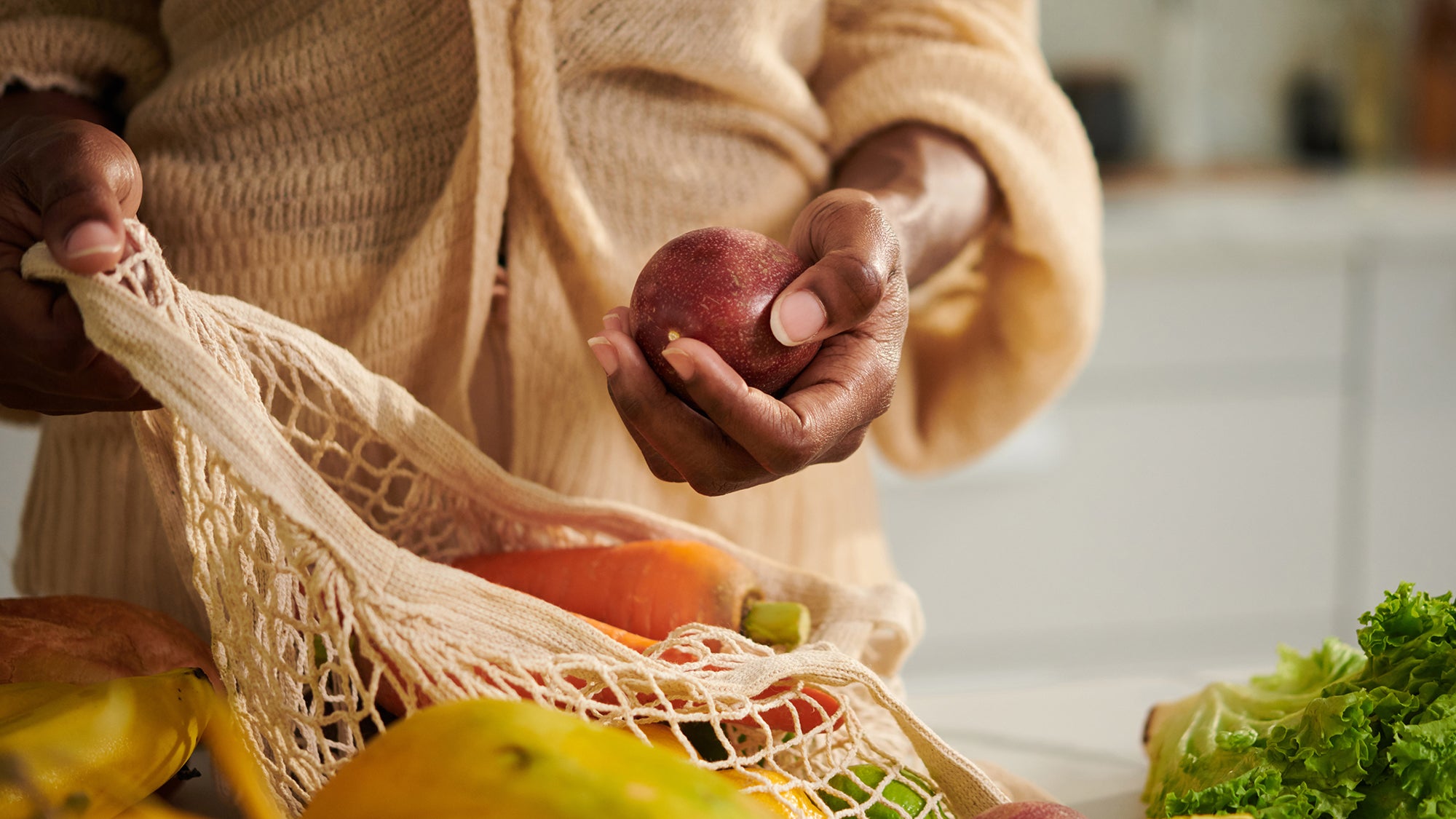 Black woman with a bag of fruits and vegetables