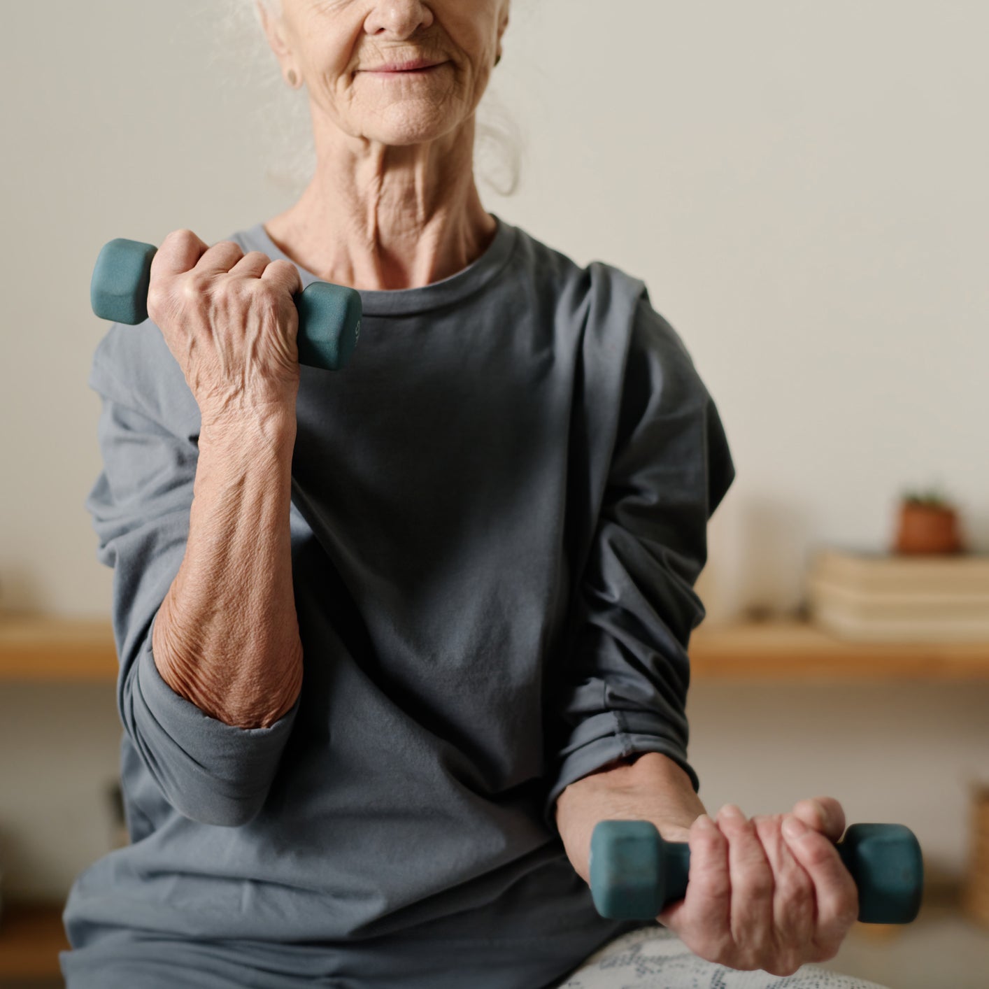 Older woman using dumbbells