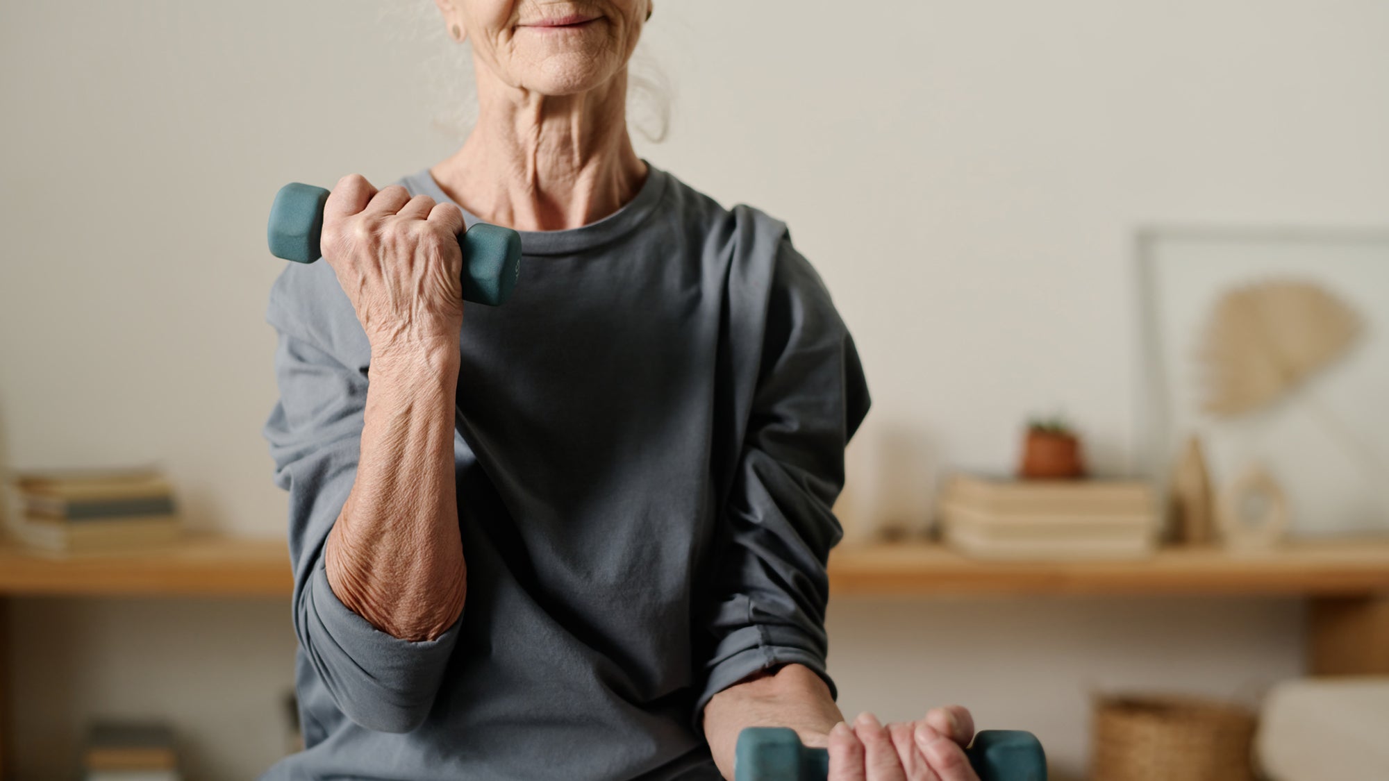 Older woman using dumbbells
