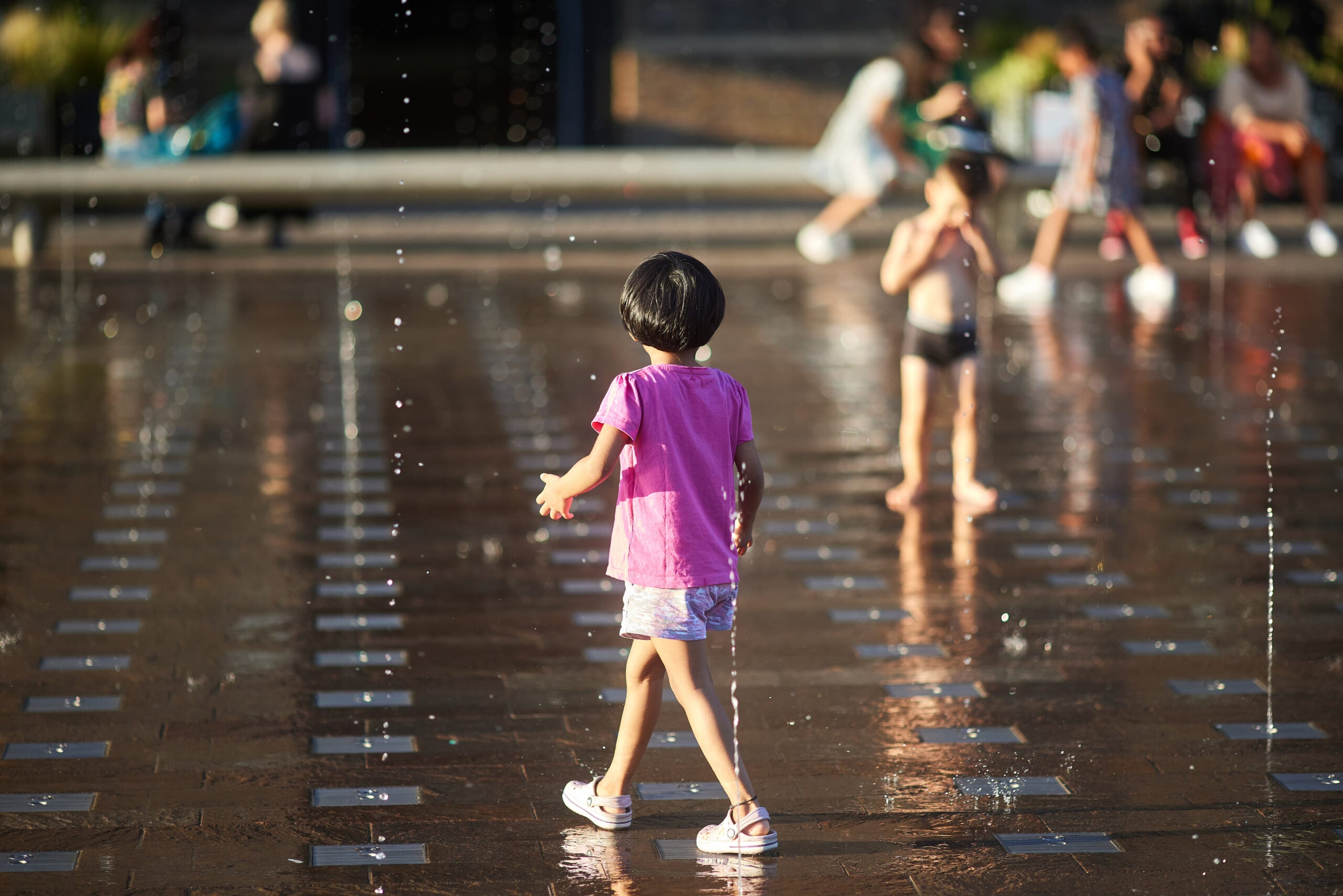 Child cooling down at a splash pad