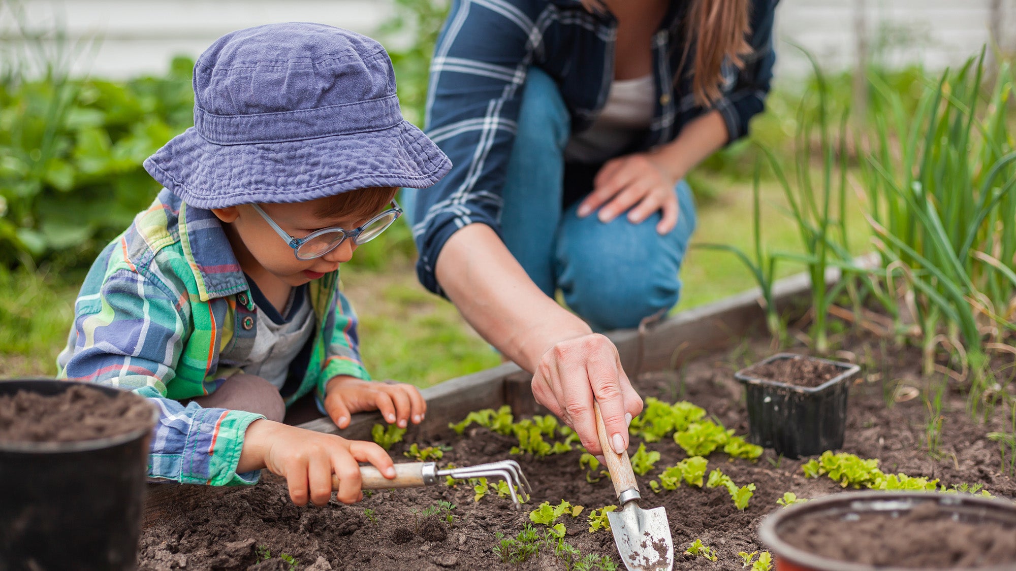 Child and mother gardening