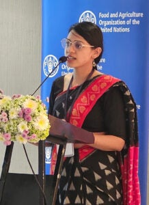 Shruti Gogia speaking at a podium