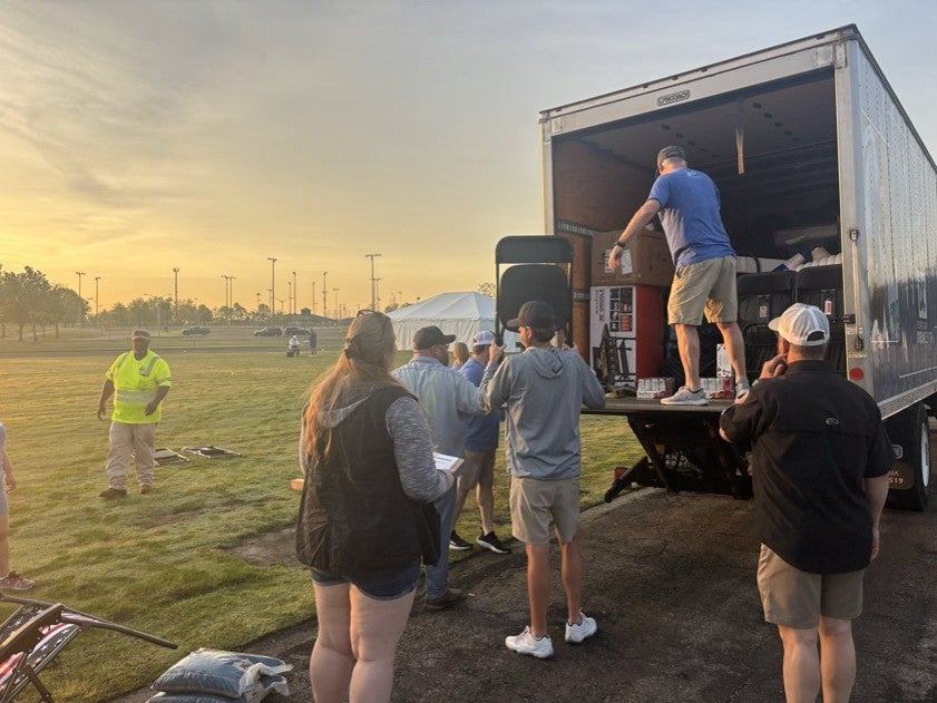 Volunteers unload the truck before a community event in DeSoto County.