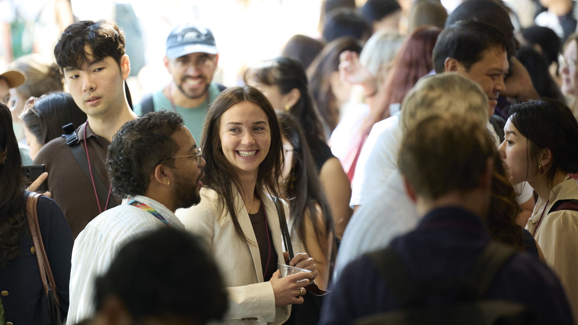 Two people chatting in a crowd.