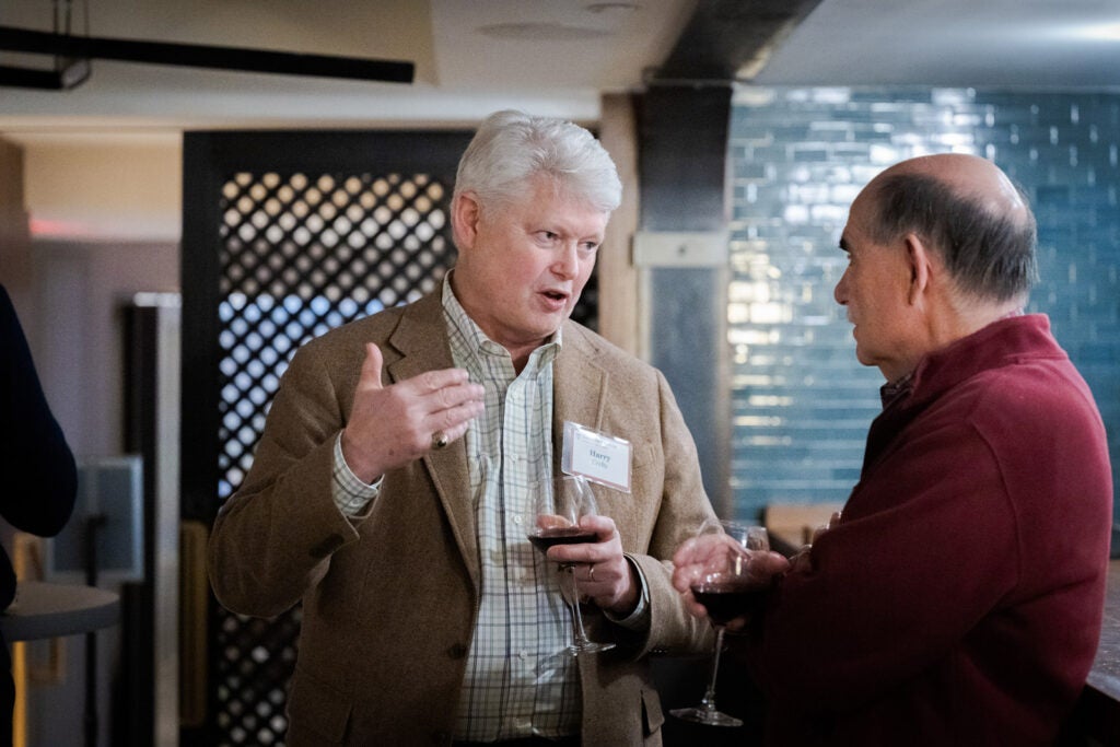 Two men in conversation at a happy hour.