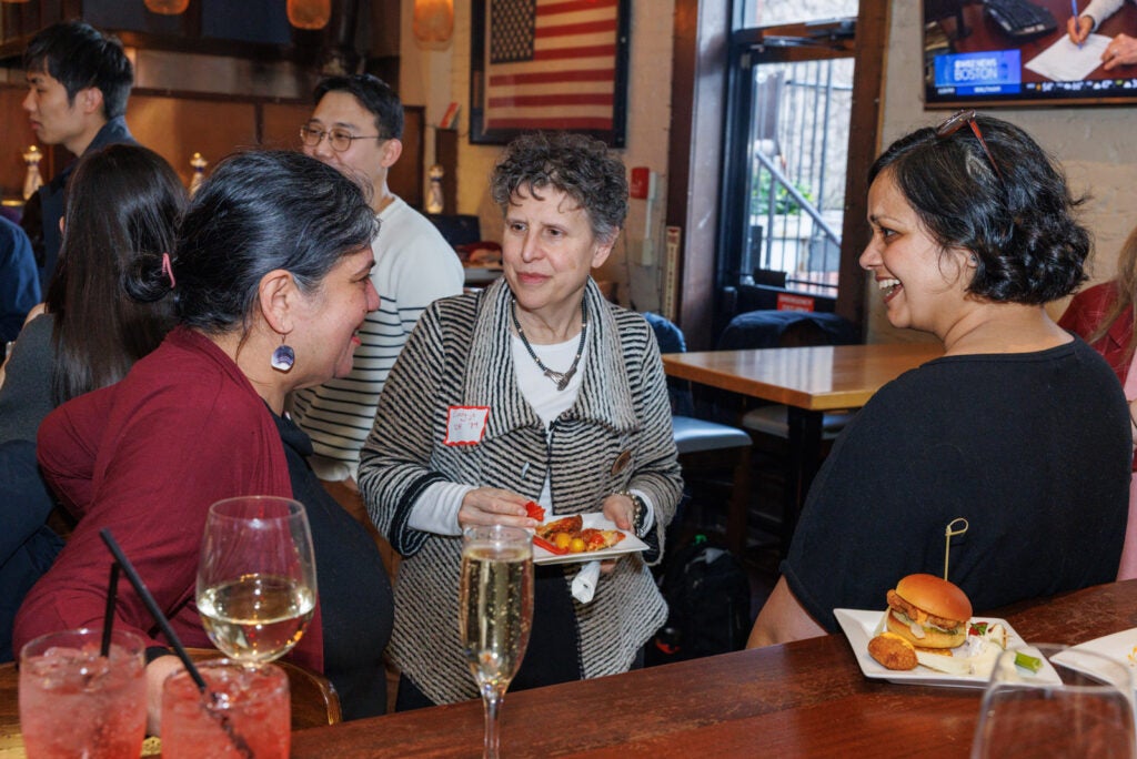 Three women converse near a bar at Dillions bar NYC.