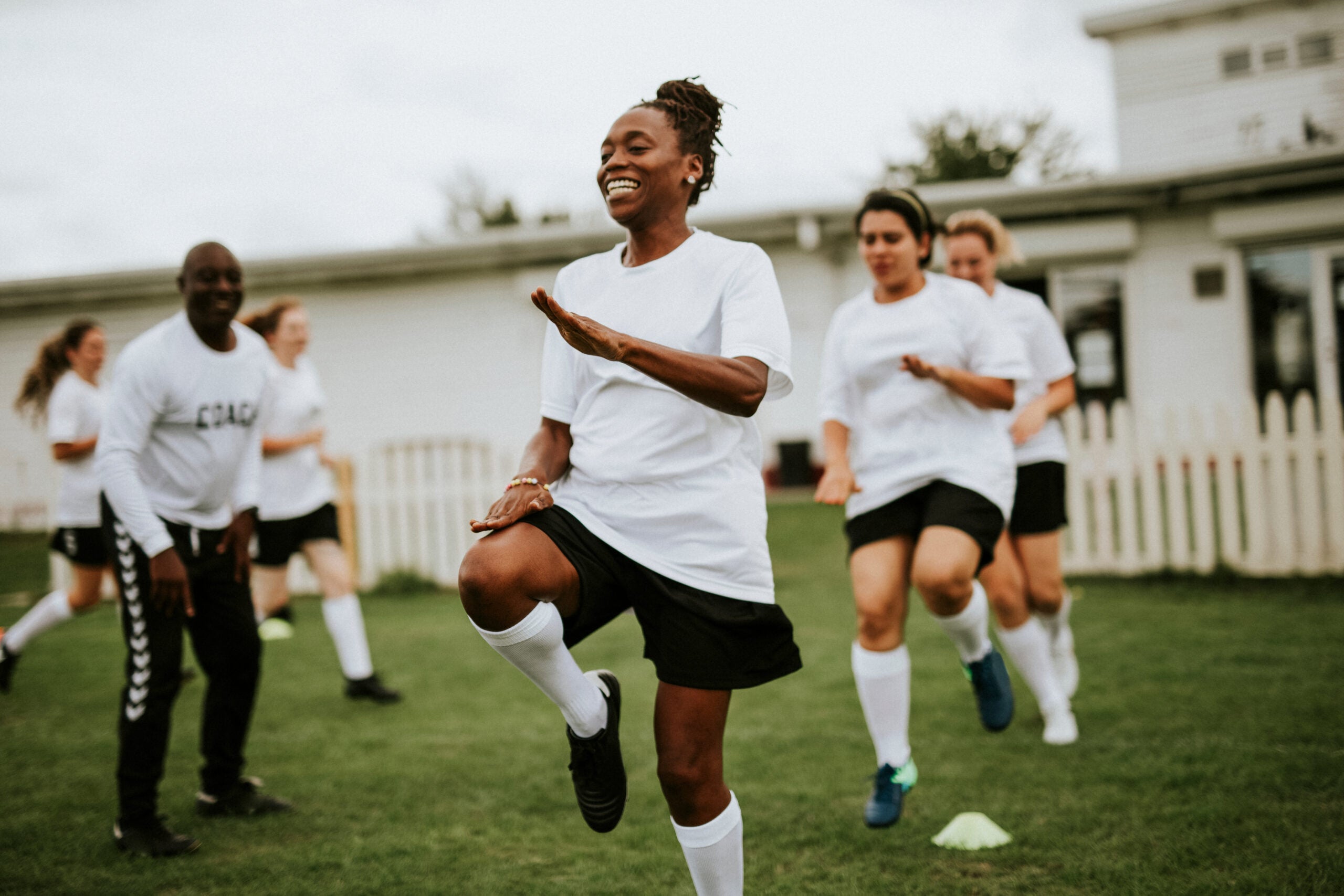 Female soccer players warming up on the field