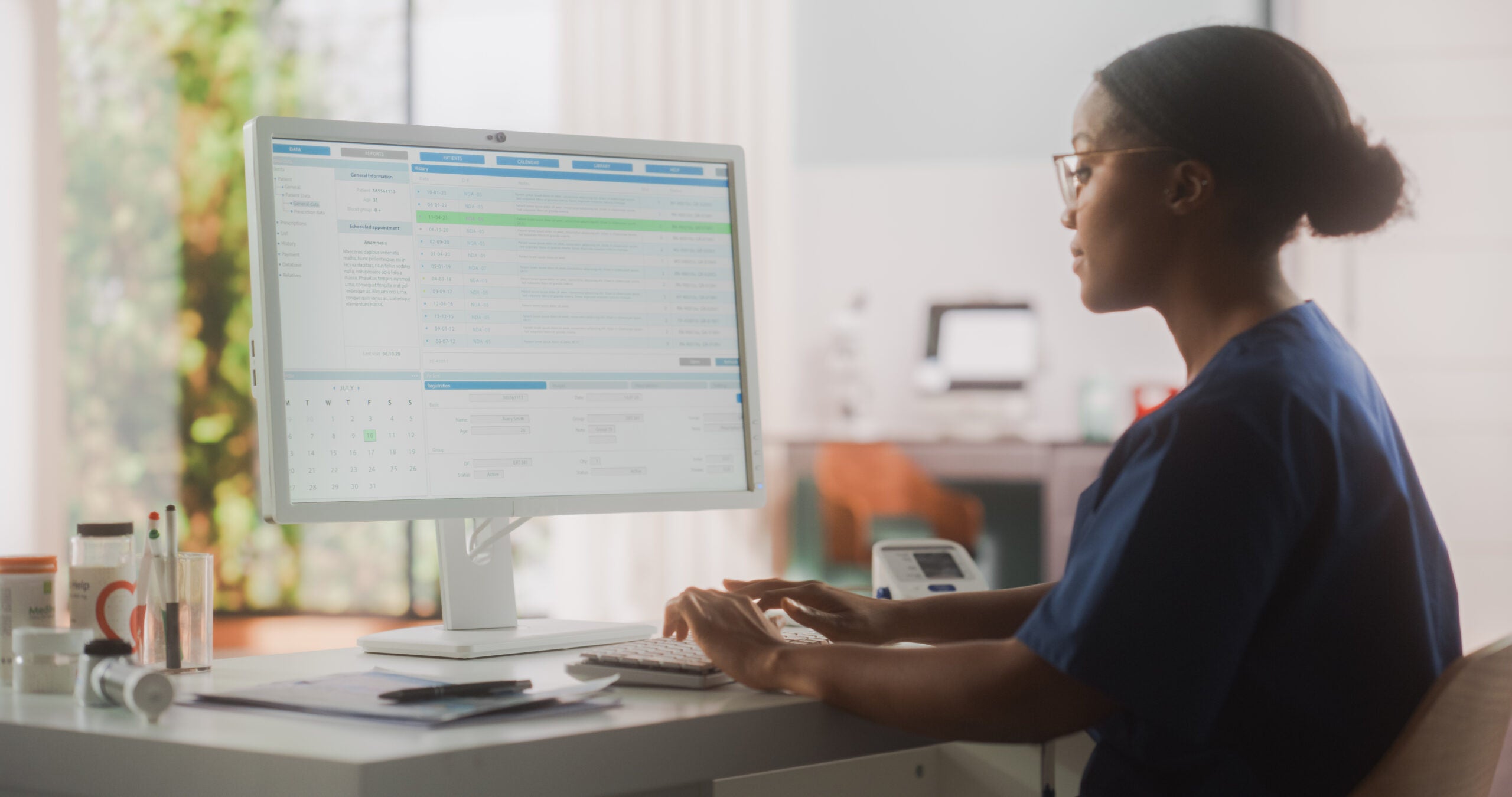 health care provider typing on a computer