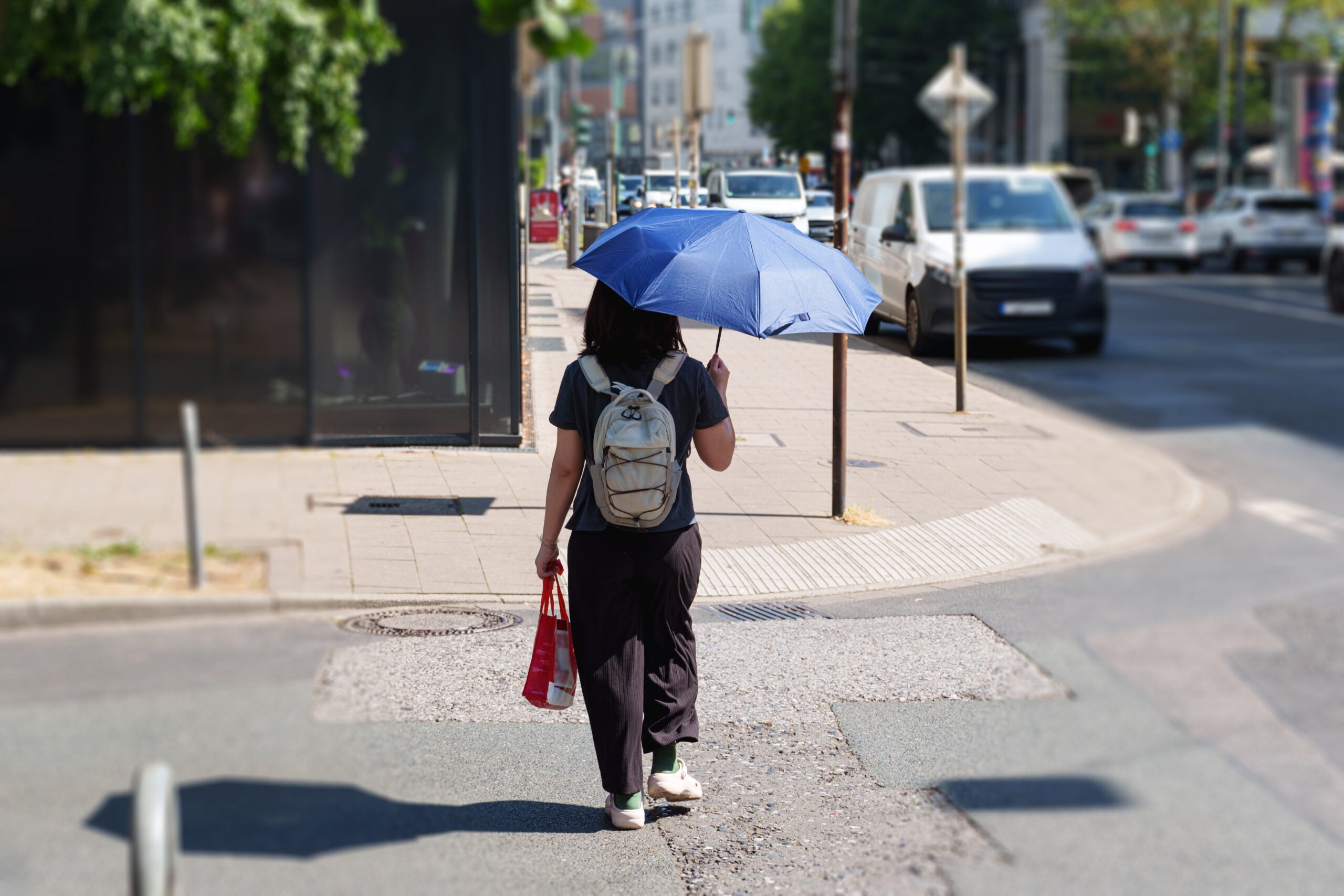 Woman using umbrella for shade