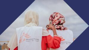 Two individuals wearing bibs that say Medecins Sans Frontieres