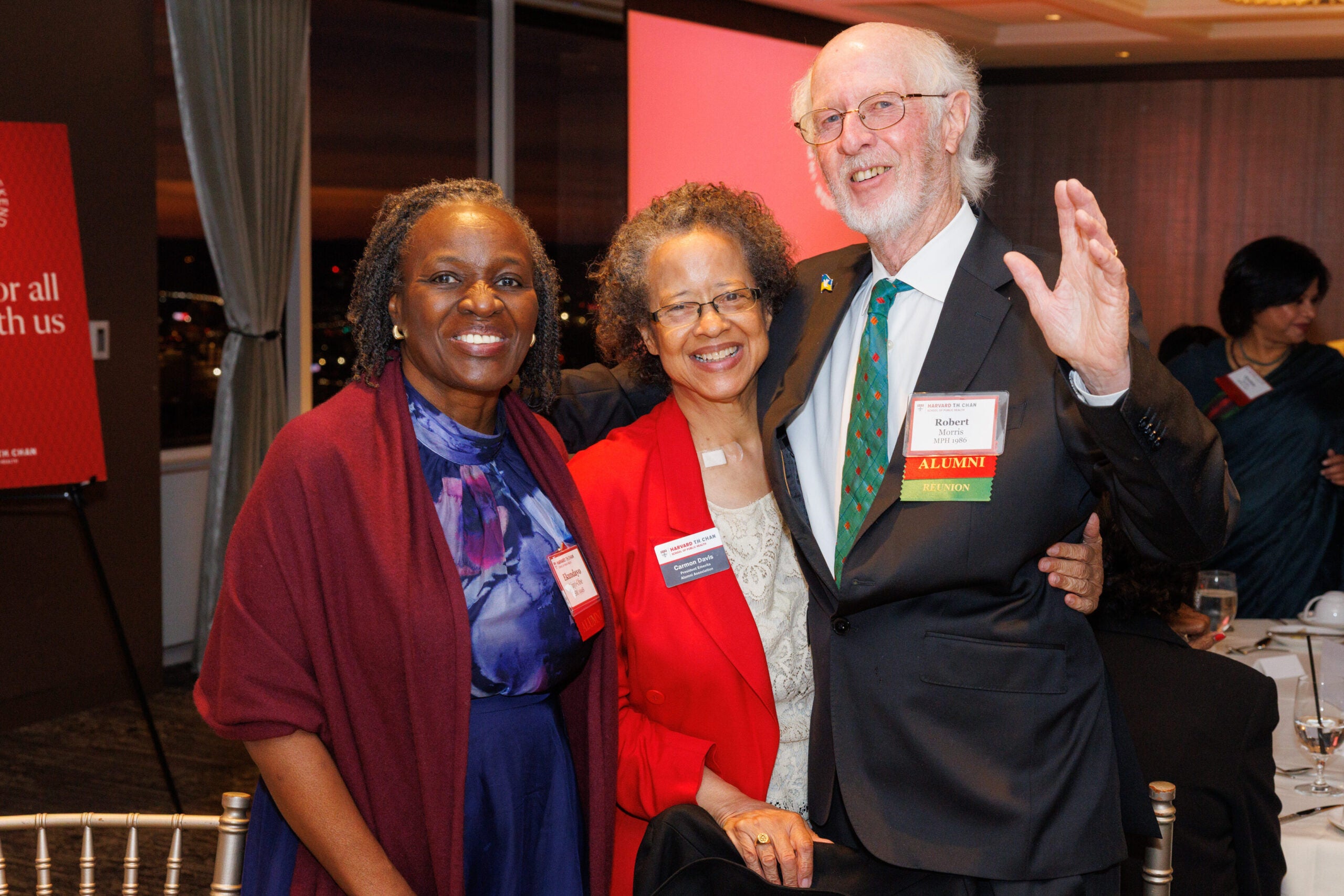 Former Harvard Chan Alumni Council President Carmon Davis poses with two fellow alumni. 