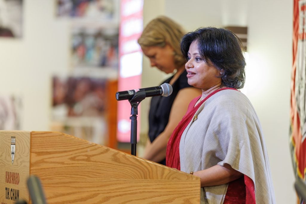 Qudsia Huda, recipient of the Leadership Award in Public Health Practice, speaks at the podium. 