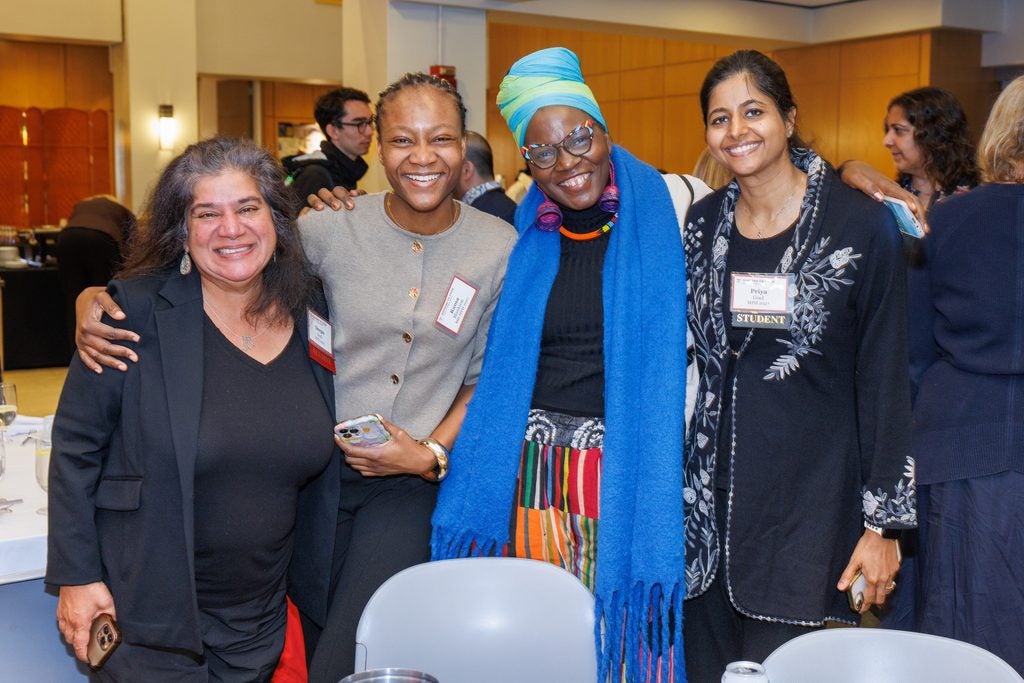 A group of alumnae and students pose together.