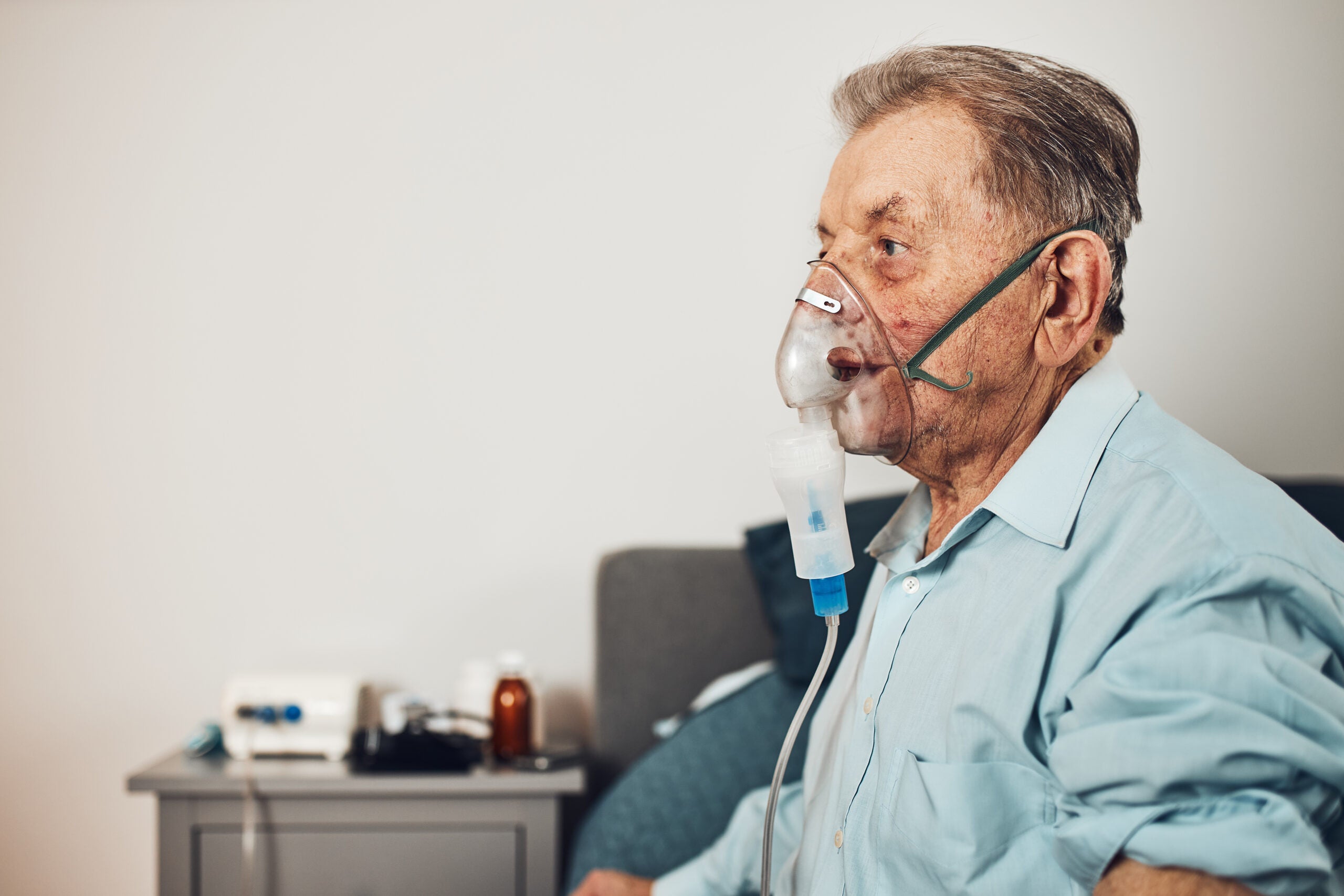 Older man using a nebulizer